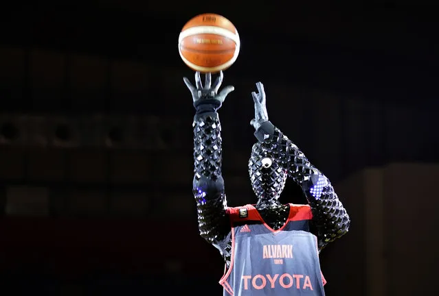 In this March 28, 2018, photo, basketball robot CUE shoots a basket at Tachihi arena in Tachikawa on the western suburbs of Tokyo. The engineers from Toyota Motor Corp., created the basketball robot that rivals professional players for free-throw accuracy.  The six-foot-two-inch (188 centimetres) tall robot is gaining a reputation in Japan and beyond for shooting hoops with pinpoint accuracy. (Photo by Shizuo Kambayashi/AP Photo)