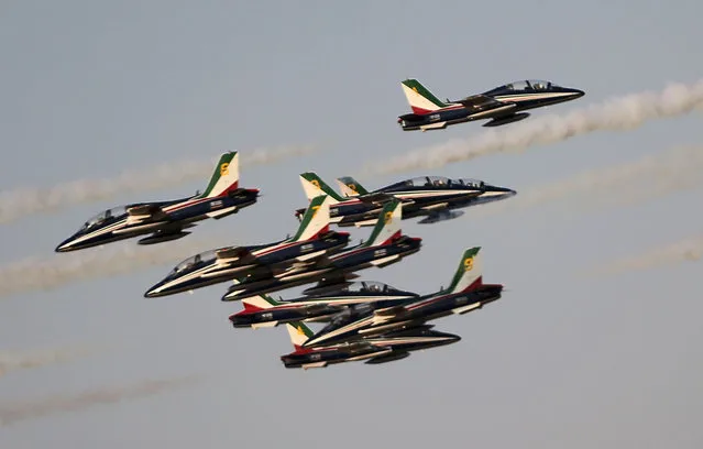 The "Frecce Tri Colori" Italian Air Force aerobatic display team perform during the opening of the Dubai Airshow in Dubai, United Arab Emirates, Sunday, November 8, 2015. (Photo by Kamran Jebreili/AP Photo)