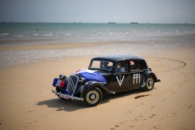 WWII military reenactors dressed as French resistance fighters drive their classic Citroen car on Gold Beach on June 03, 2024 in Arromanches Les Bains, France. Normandy is hosting a variety of events across significant sites such as Pegasus Bridge, Sainte-Mère-Église, and Pointe du Hoc, leading up to the official commemoration of the 80th anniversary of the D-Day landing on June 6. (Photo by Christopher Furlong/Getty Images)