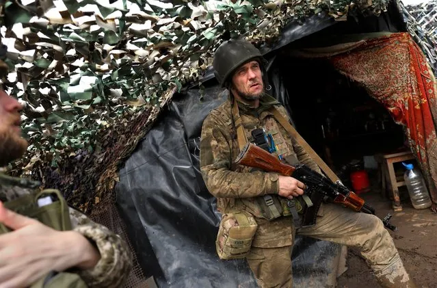 Ukrainian service man Yuzik (43) of the 24th brigade takes cover at the trenches at the frontline, amid Russia?s attack on Ukraine, near Niu York, Donetsk region, Ukraine on April 4, 2023. (Photo by Kai Pfaffenbach/Reuters)