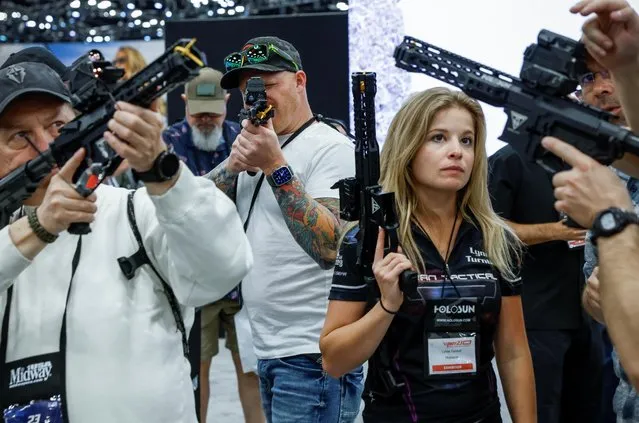 Attendees try out laser sights at the Holosun booth during the National Rifle Association (NRA) annual convention in Indianapolis, Indiana, U.S., April 15, 2023. (Photo by Evelyn Hockstein/Reuters)