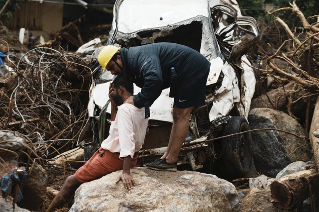 A rescuer consoles a man who lost his home following Tuesday's landslides at Chooralmala, Wayanad district, Kerala state, India, Wednesday, July 31, 2024. (Photo by Rafiq Maqbool/AP Photo)