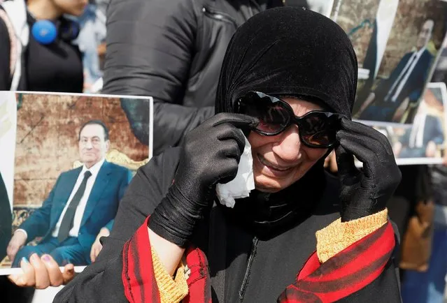 A supporter of former Egyptian President Hosni Mubarak reacts at a gathering near the main gate of a cemetery during his burial ceremony, east of Cairo, Egypt on February 26, 2020. (Photo by Mohamed Abd El Ghany/Reuters)