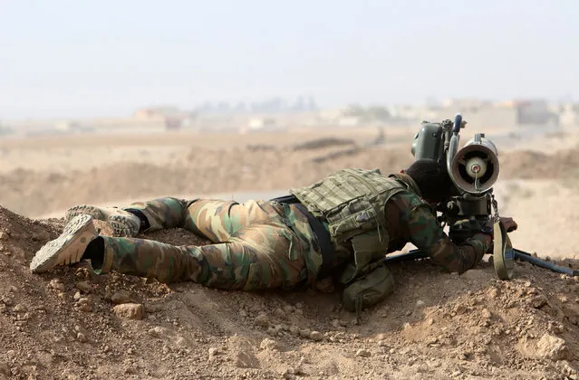 A Kurdish Peshmerga fighter looks through a Milan missile before recapturing from Islamic state militants the Fadiliya village in Nawaran, north of Mosul, Iraq, October 27, 2016. (Photo by Air Jalal/Reuters)