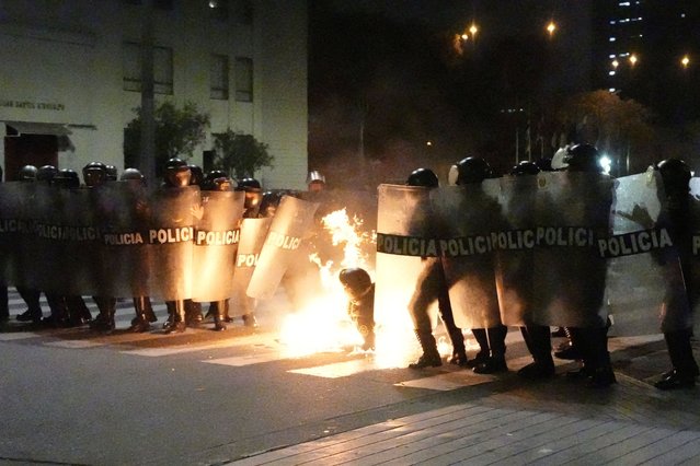 A Molotov cocktail falls on a police officer during a demonstration organised by a youth collective called “Generation Z” to express discontent over a controversial pension reform plan, as well as the government of Peru's President Dina Boluarte, whose approval ratings have plummeted due to ongoing scandals and rising crime, in Lima, Peru on September 28, 2025. (Photo by Angela Ponce/Reuters)