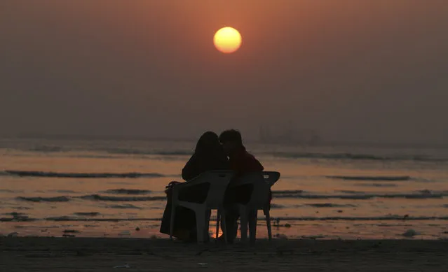 A Pakistani couple enjoys the last sunset of the year at Karachi beach, Wednesday, December 31, 2014, in Pakistan. (Photo by Fareed Khan/AP Photo)