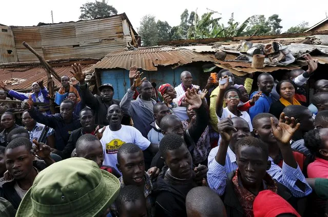 Faithful wave during Pope Francis' visit at the Kangemi slums on the outskirts of Kenya's capital Nairobi, November 27, 2015. (Photo by Stefano Rellandini/Reuters)