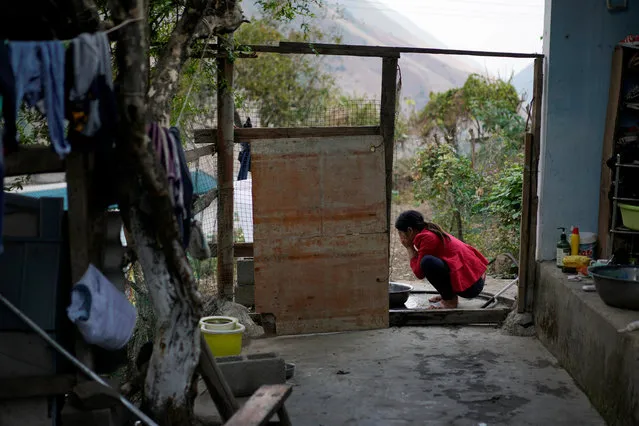 Cha Huilan, a 40-year old Lisu woman, washes her face in her home in Lazimi village in Nujiang Lisu Autonomous Prefecture in Yunnan province, China, March 24, 2018. (Photo by Aly Song/Reuters)