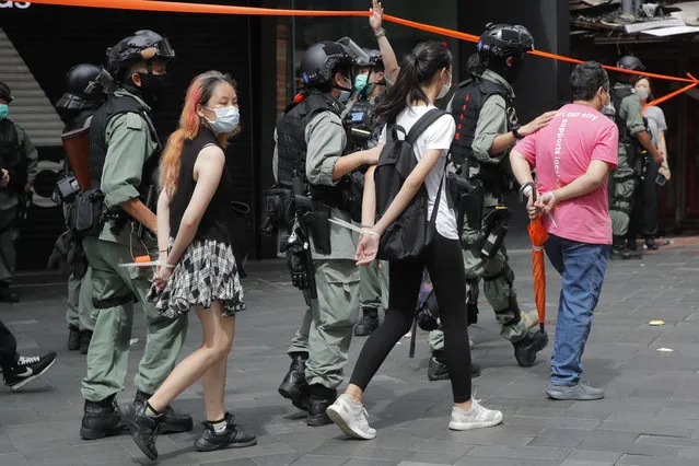 Police detain protesters after a protest in Causeway Bay before the annual handover march in Hong Kong, Wednesday, July. 1, 2020. (Photo by Kin Cheung/AP Photo)