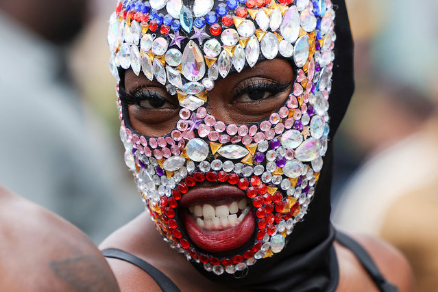 A reveller wears a mask during Notting Hill Carnival, in London, Britain on August 25, 2024. (Photo by Hollie Adams/Reuters)