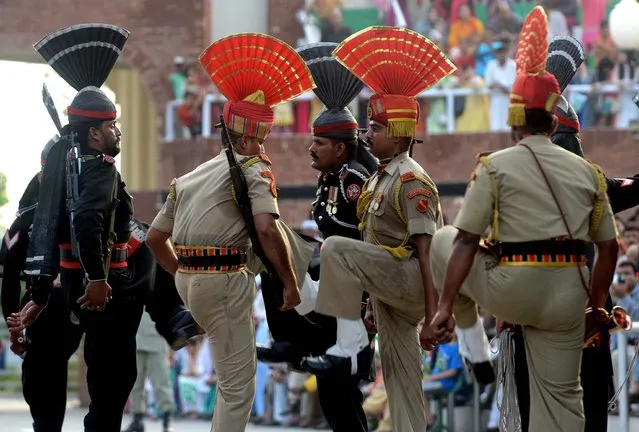 Pakistani rangers and security guards Indian borders are preparing for a ceremony near the border at Wagah, July 9, 2013. (Photo by Narinder Nanu/AFP Photo)