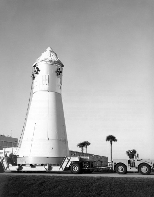 America's Apollo 1 spacecraft, perched atop a special truck at Cape Kennedy in Florida on January 6, 1966, moved to the launch pad as preparations moved ahead to launch the nation's first three-man astronaut crew into orbit about February 21. The Apollo 1 spaceship is to carry air force Lt. Cols. Virgil I. Grissom and Edward H. White II and Navy Lt. Cmdr. Roger B. Chaffee into Earth orbit to spend up to 14 days checking out spacecraft operations. (Photo by AP Photo)