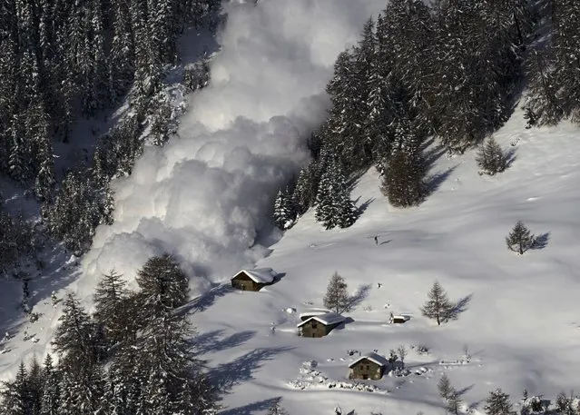 An artificially triggered avalanche thunders down a mountain side at the Vallee de la Sionne in Anzere near Sion, February 3, 2015. The full-scale avalanche dynamics test site is providing scientists and engineers of the Swiss Institute of Research of Snow and Avalanches with essential data to understand and model avalanche motion, according to the Institute website. (Photo by Denis Balibouse/Reuters)
