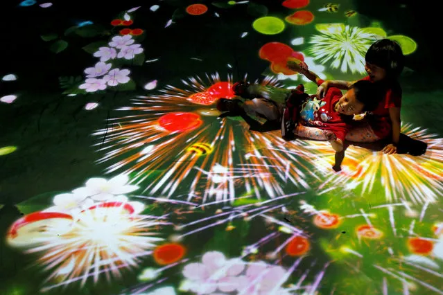 Children play at a digital installation in New Taipei City, Taiwan August 9, 2018. (Photo by Tyrone Siu/Reuters)