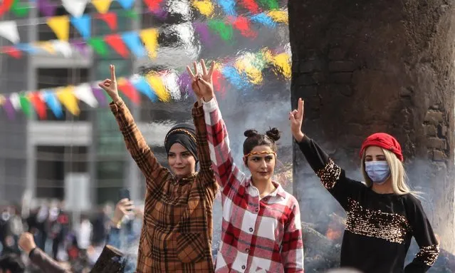 Supporters of pro-Kurdish Peoples' Democratic Party (HDP) gather to celebrate Newroz, which marks the arrival of spring, in Diyarbakir, Turkey March 21, 2021. (Photo by Sertac Kayar/Reuters)
