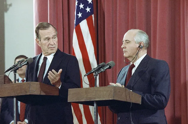 In this October 29, 1991, file photo, President George H.W. Bush gestures during a joint news conference with Soviet President Mikhail Gorbachev,  at the Soviet Embassy in Madrid. Bush died at the age of 94 on Friday, November 30, 2018, about eight months after the death of his wife, Barbara Bush. (Photo by Jerome Delay/AP Photo)
