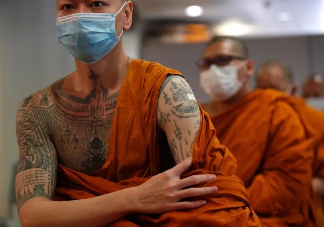 A Thai Buddhist monk has a plaster over his tattoo after receiving a shot of the vaccine against COVID-19 developed by AstraZeneca during a national inoculation program for Buddhist monks at a temple in Bangkok, Thailand, 31 March 2021. Thailand initiated its national inoculation program of vaccinations against COVID-19 for medical staff and at-risks groups to curb the ongoing COVID-19 and coronavirus pandemic. (Photo by Rungroj Yongrit/EPA/EFE)