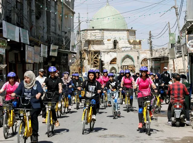Iraqi women ride bicycles during a cycling activity in Mosul, Iraq, April 12, 2021. (Photo by Khalid al-Mousily/Reuters)