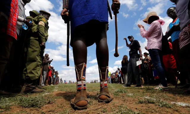 A Maasai moran dressed in recycled tire shoes prepares to throw a traditional club, known as rungu, as he competes in the 2016 Maasai Olympics at the Sidai Oleng Wildlife Sanctuary, at the base of Mt. Kilimanjaro, near the Kenya-Tanzania border in Kimana, Kajiado, Kenya December 10, 2016. (Photo by Thomas Mukoya/Reuters)
