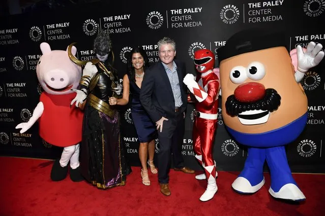 The Paley Center for Media president and CEO Maureen Reid, left, and Hasbro, Inc. CEO Chris Cocks pose with Hasbro toy characters at The Paley Honors: A Gala Tribute to Hasbro's Centennial, hosted by The Paley Center for Media, at Cipriani 42nd Street on Monday, October 23, 2023, in New York. (Photo by Evan Agostini/Invision/AP Photo)