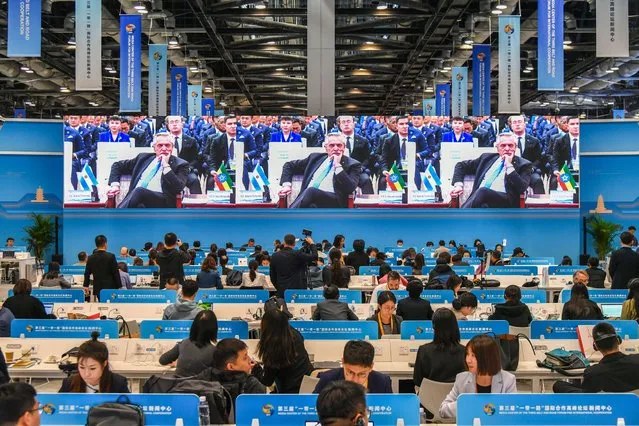 Journalists watch a screen showing a live broadcast of Argentine President Alberto Fernandez reacing during the opening ceremony of the third Belt and Road Forum for International Cooperation at the Media Center on October 18, 2023 in Beijing, China. (Photo by VCG/VCG via Getty Images)