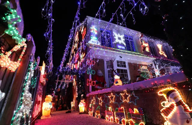 A house decorated with Christmas lights in Hampshire, England on December 5, 2018. A group of residents on the street all decorate their homes to raise money for local charities. (Photo by Andrew Matthews/PA Wire Press Association)