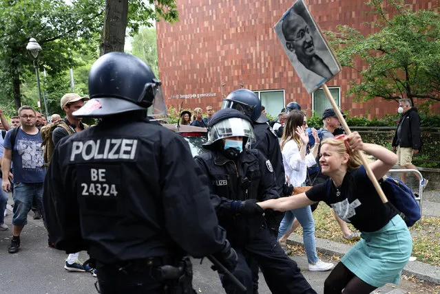 Police members detain a demonstrator during a protest against government measures to curb the spread of coronavirus disease (COVID-19) in Berlin, Germany August 1, 2021. (Photo by Christian Mang/Reuters)