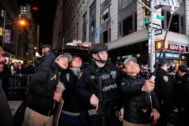 People take a selfie with a member of the counter terrorism task force in Times Square in New York, U.S. January 1, 2017. (Photo by Stephanie Keith/Reuters)