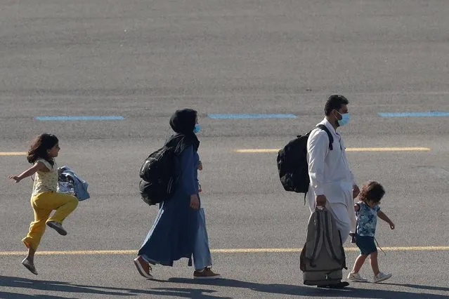 People who have been evacuated from Afghanistan arrive at Melsbroek military airport after Taliban insurgents entered Afghanistan's capital Kabul, Melsbroek, Belgium, August 25, 2021. (Photo by Johanna Geron/Reuters)