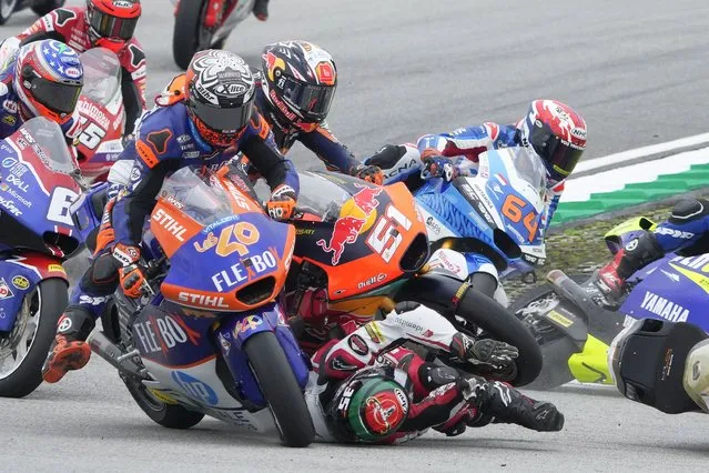 Spain's Pedro Acosta of Red Bull KTM Ajo, top center, crashes with Thailand's Somkiat Chantra of Idemitsu Honda Team Asia during the Moto2 race for the Malaysia Motorcycle Grand Prix in Sepang International Circuit, Sunday, October 23, 2022. (Photo by Vincent Thian/AP Photo)