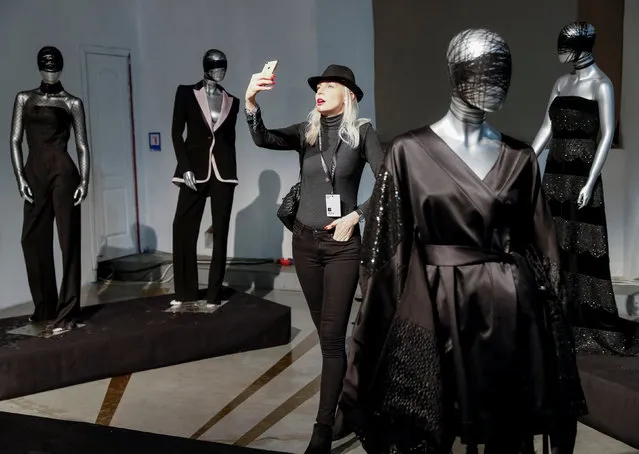 A visitor takes a selfie at an exhibition of creations by Ukrainian designer Sergey Ermakov during Ukrainian Fashion Week in Kiev, Ukraine February 5, 2019. (Photo by Gleb Garanich/Reuters)