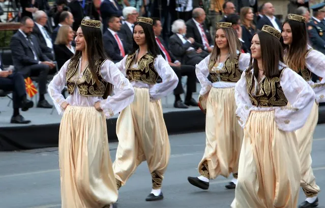 Women in traditional clothing take part in a parade to mark the Independence Day in downtown Skopje, North Macedonia, Wednesday, September 8, 2021. (Photo by Boris Grdanoski/AP Photo)