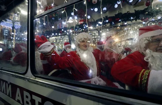 Musicians dressed as Father Frost (the Russian version of Santa Claus) perform during their journey on a bus along Nevsky Prospekt Avenue ahead of the Christmas and New Year celebrations in St. Petersburg, Russia, 29 December 2023. Russians celebrate New Year's Eve on 31 December and Christmas on 07 January, according to the Russian Orthodox Julian calendar, 13 days after Christmas Day in the Gregorian calendar on 25 December. (Photo by Anatoly Maltsev/EPA)