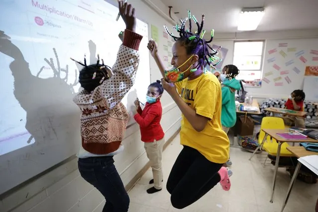 Niambi Cameron, right, celebrates with classmates after answering a question during a math lesson at the Kilombo Academic and Cultural Institute in Decatur, Ga., on March 28, 2023. (Photo by Alex Slitz/AP Photo)