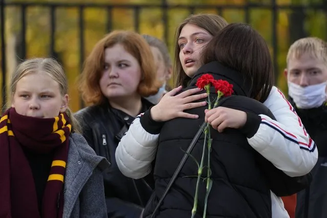 Students comfort each other as they gather outside the Perm State University following a campus shooting in Perm, about 1,100 kilometers (700 miles) east of Moscow, Russia, Tuesday, September 21, 2021. A student opened fire at the university, leaving a number of people dead and injured, before being shot in a crossfire with police and detained. Beyond saying that he was a student, authorities offered no further information on his identity or a possible motive. (Photo by Dmitri Lovetsky/AP Photo)