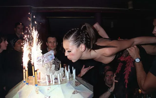 British model Kate Moss blows out the candles on the cake at her 25th Birthday party in Paris, France, 1999. (Photo by Richard Young/Rex Features/Shutterstock)