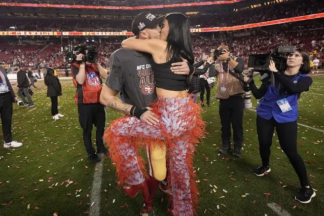 San Francisco 49ers tight end George Kittle, middle left, celebrates with his wife, Claire, after the NFC Championship NFL football game against the Detroit Lions in Santa Clara, Calif., Sunday, January 28, 2024. (Photo by Mark J. Terrill/AP Photo)