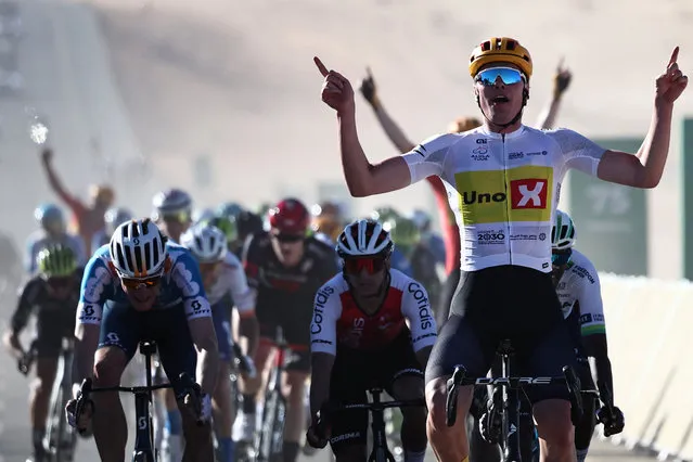 Norway's Soren Waerenskjold (Uno-X) gestures as he crosses the finish line to win the second stage of al-Ula Tour cycling race in Al-Ula on January 31, 2024. (Photo by Anne-Christine Poujoulat/AFP Photo)