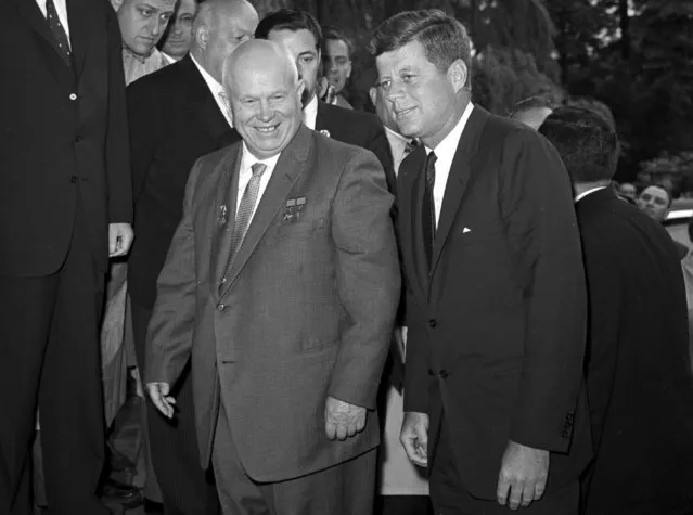 Soviet Premier Nikita Khrushchev, left, walks with U.S. President John F. Kennedy at the residence of the U.S. ambassador in Vienna, Austria on June 3, 1961. The invasion of Ukraine has rapidly returned echoes of a Cold War mentality to the United States, with a familiar foe in Russia. (Photo by AP Photo/File)