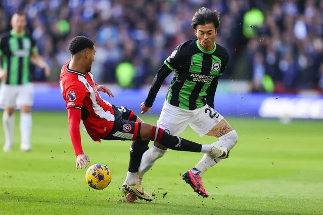 Kaoru Mitoma of Brighton and Hove Albion is fouled by Mason Holgate of Sheffield United resulting in a red card during the Premier League match between Sheffield United and Brighton & Hove Albion at Bramall Lane on February 18, 2024 in Sheffield, England. (Photo by James Gill - Danehouse/Getty Images)