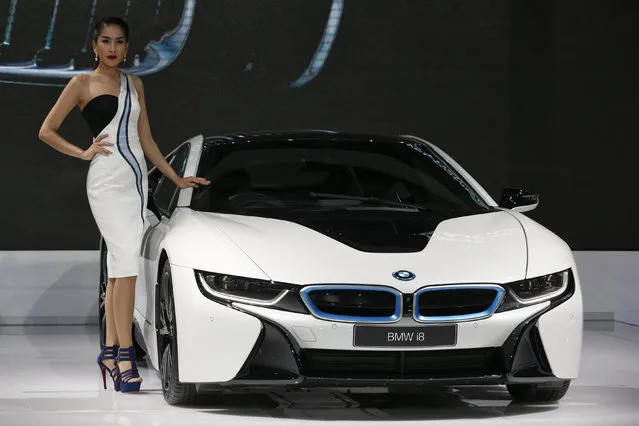 A model poses beside a BMW i8 during a media presentation at the 37th Bangkok International Motor Show in Bangkok, Thailand, March 22, 2016. (Photo by Chaiwat Subprasom/Reuters)