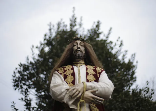 A statue of Jesus Christ is seen before the start of the procession of the “Ultima Cena del Salvador” brotherhood during Holy Week in Santiago de Compostela, northern Spain March 24, 2016. (Photo by Miguel Vidal/Reuters)
