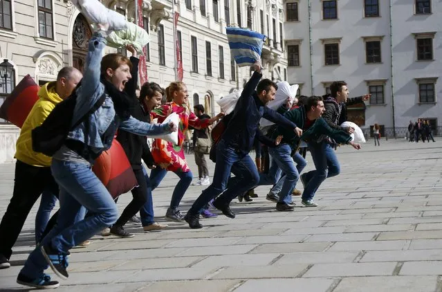 People start to fight with pillows during World Pillow Fight Day in Vienna, Austria, April 2, 2016. (Photo by Leonhard Foeger/Reuters)