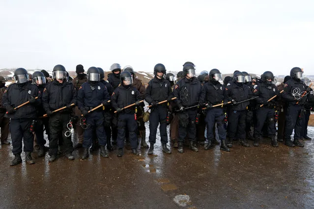 Police confront protesters refusing to evacuate the main opposition camp against the Dakota Access oil pipeline near Cannon Ball, North Dakota, U.S., February 22, 2017. (Photo by Terray Sylvester/Reuters)