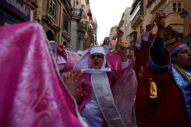 Dancers wearing costumes sing and dance during the carnival street parade in Valletta, Malta, February 25, 2017. (Photo by Darrin Zammit Lupi/Reuters)