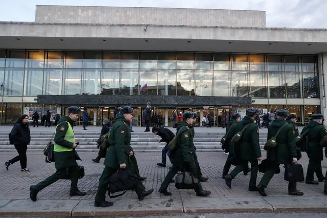 Military cadets walk in front of the Oktyabrsky Concert Hall, amid heightened security measures, prior to the concert of the rock group “Picnic” in St. Petersburg, Russia, 27 March 2024. (Photo by Anatoly Maltsev/EPA/EFE)