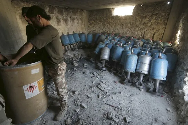 Rebel fighters prepare locally made shells during clashes with forces loyal to Syria's President Bashar al-Assad on the frontline of Aleppo's Sheikh Saeed neighbourhood May 23, 2015. Rebel fighters from Al-Fawj al-Awal, al-Safwa battalions and group 101 brigades, that are part of the Free Syrian Army, made advances against forces loyal to Syria's President Bashar al-Assad during Aleppo Intifada battles, they said. (Photo by Hosam Katan/Reuters)