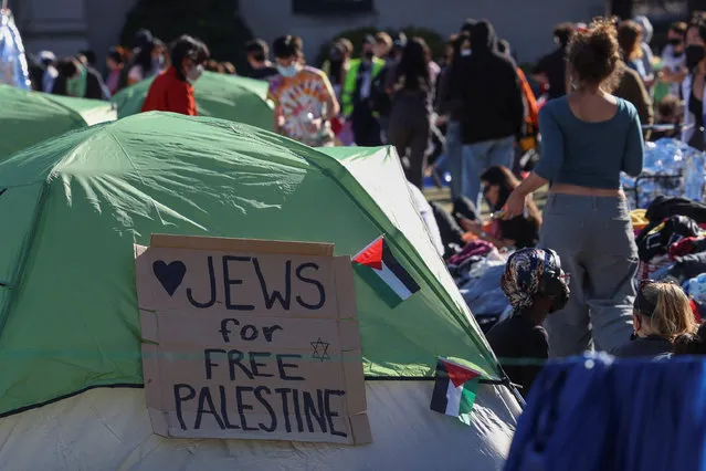 Signs are seen posted around the protest encampment in support of Palestinians at Columbia University, during the ongoing conflict between Israel and the Palestinian Islamist group Hamas, in New York City, April 22, 2024. (Photo by Caitlin Ochs/Reuters)