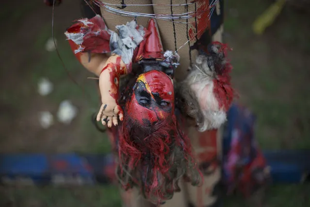 A doll forms part of a sculpture as part of an exhibit titled The Sea Isnt Made for Fish at Rio de Janeiro Federal University in Rio de Janeiro, Brazil, Monday, June 1, 2015. Art students have taken advantage of a material they have in endless supply trash to create an exhibition that aims to draw attention to the fetid state of the citys Guanabara Bay, where the Olympic sailing events are to be held next year. (AP Photo/Silvia Izquierdo)