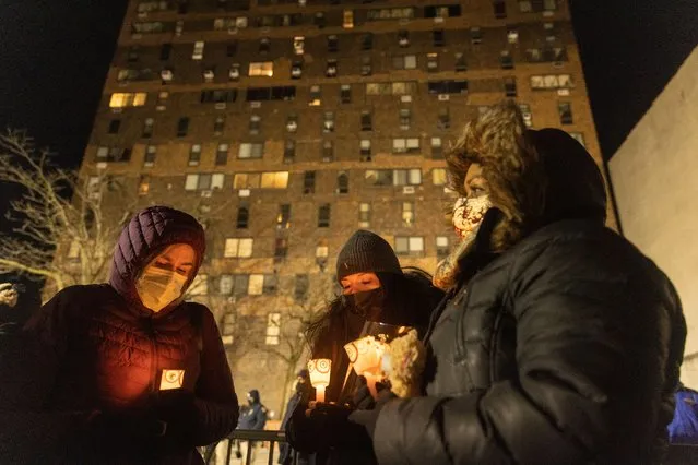 People attend a candlelight vigil following a fire at a multi-level apartment building in the Bronx neighborhood of New York on January 11, 2022. (Photo by Jeenah Moon/The Washington Post)